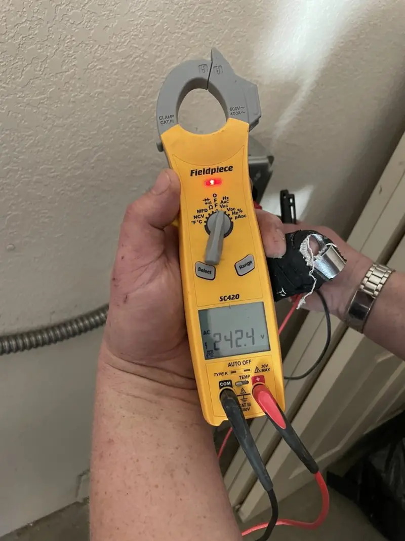 Voltage testing with clamp meter during Recessed Lighting Installation in Barrett